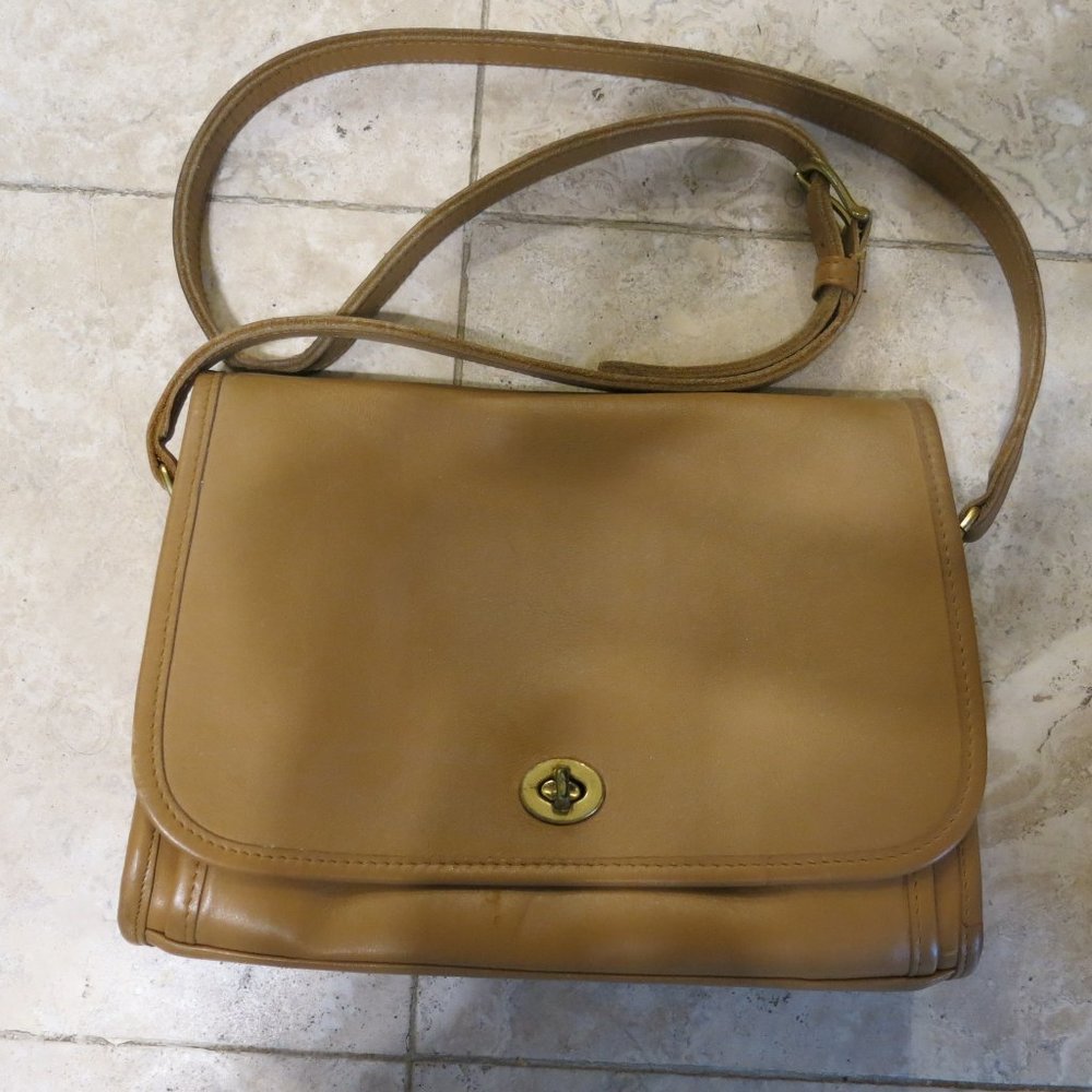 Tan and gold tone colored Coach shoulder bag